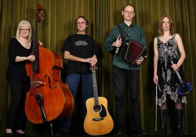 Vertical Expression's publicity photo with four musicians holding a fiddle, a melodeon, a guitar and a double bass